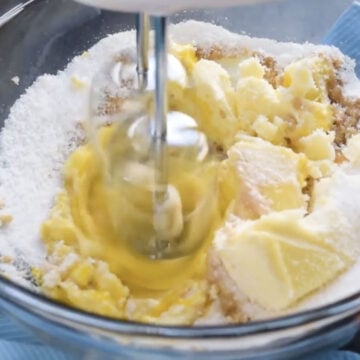 Creaming together butter, eggs, Splenda and vanilla in glass bowl. 