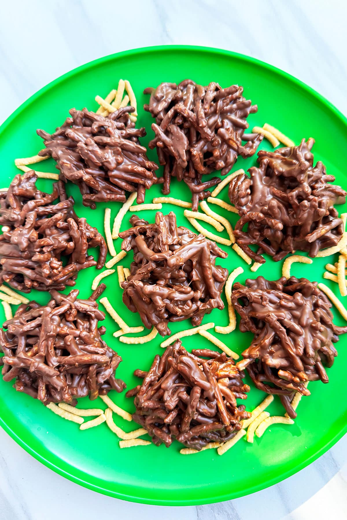 Easy No Bake Haystack Cookies With Chocolate Chips And Butterscotch on Green Dish.