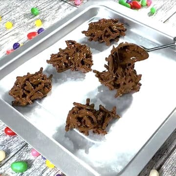 Chow mein cookie clusters being scooped onto lined tray. 