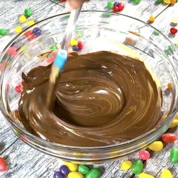 Melted chocolate, butterscotch and peanut butter mixture in glass bowl. 