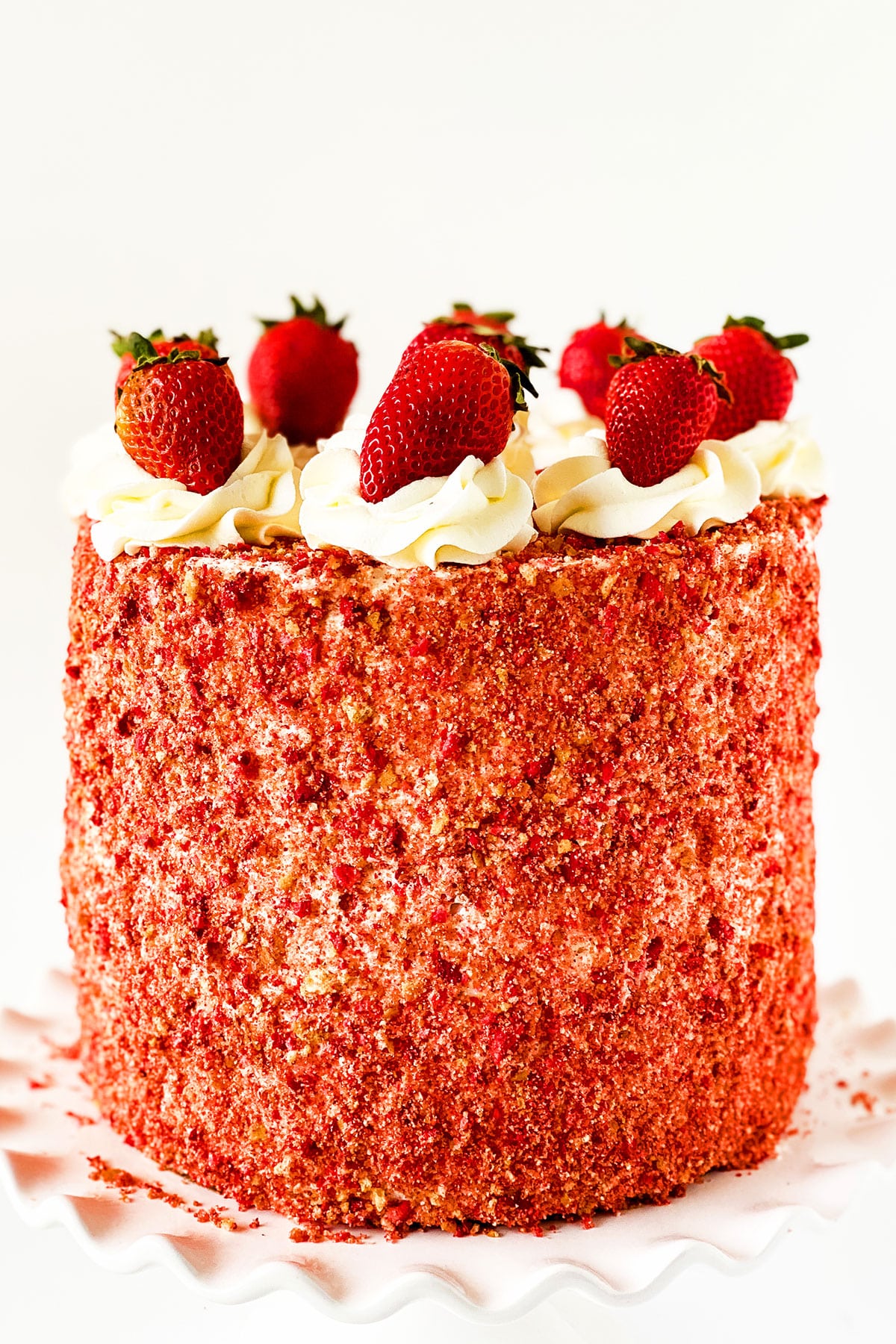 Layered Strawberry Crunch Cake With Cake Mix Box Covered in Buttercream Frosting and Crunchy Topping and Fresh Strawberries. 