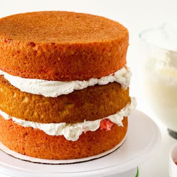 Three cake layers stacked with buttercream icing in between them. 