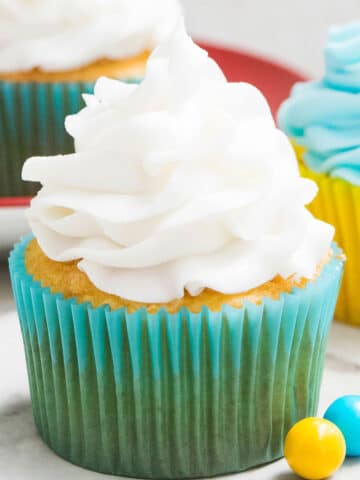 Easy 2 Ingredient White Chocolate Buttercream Frosting Swirled on Top of Cupcake.