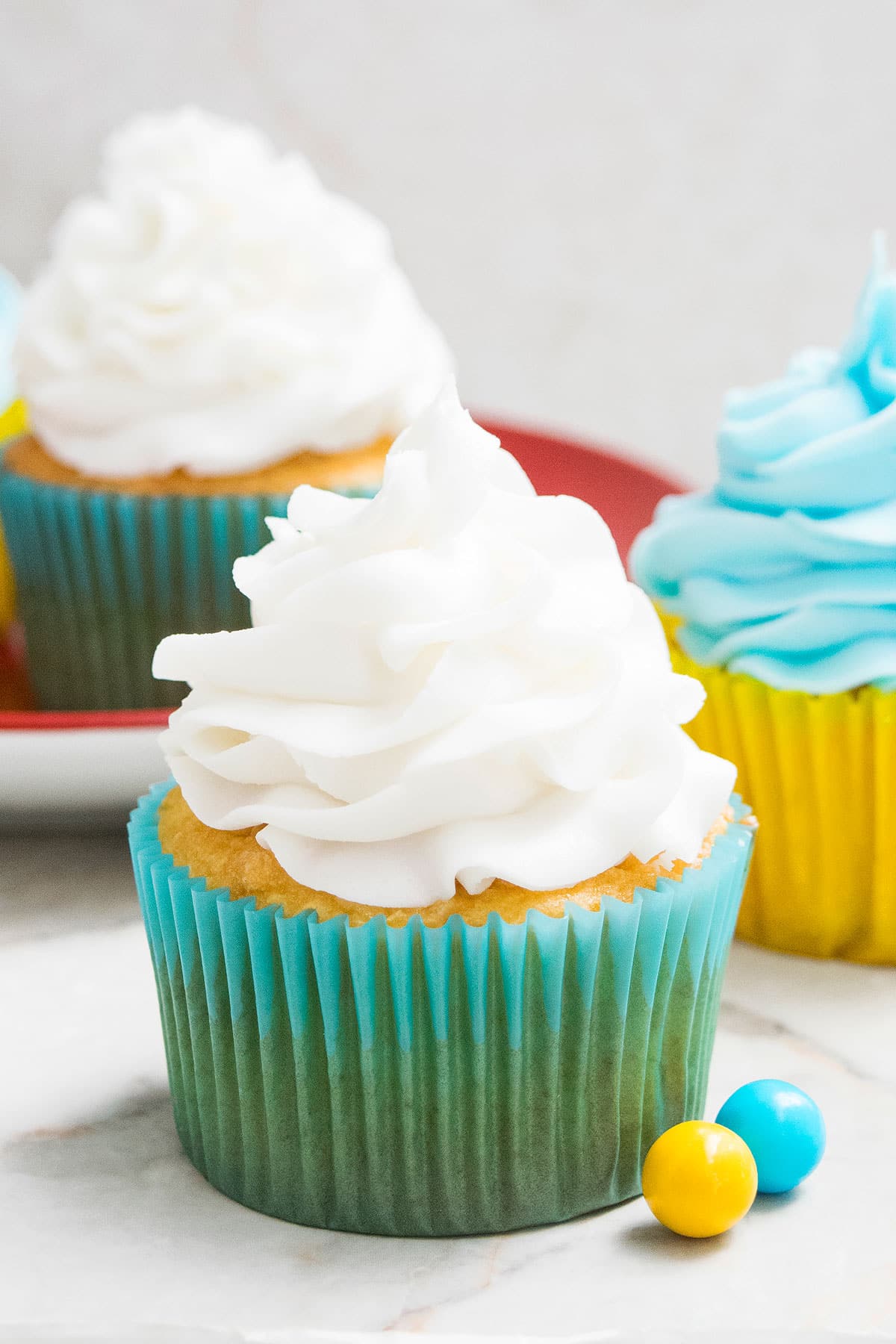 Easy White Chocolate Buttercream Frosting Swirled on Top of Cupcake. 