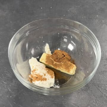 Pumpkin puree, cream cheese, butter, pumpkin pie spice in glass bowl. 