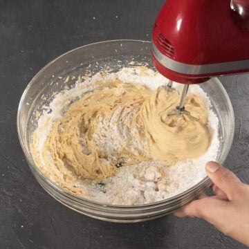 Powdered sugar being mixed into the buttercream. 