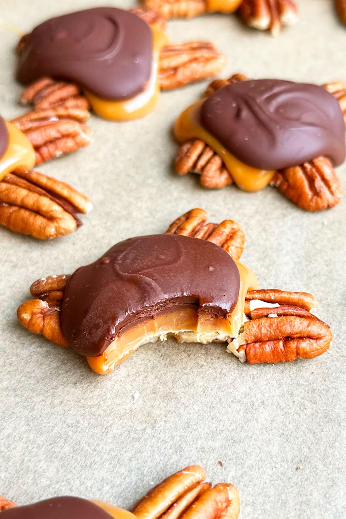 Partially eaten candy on brown wax paper. 