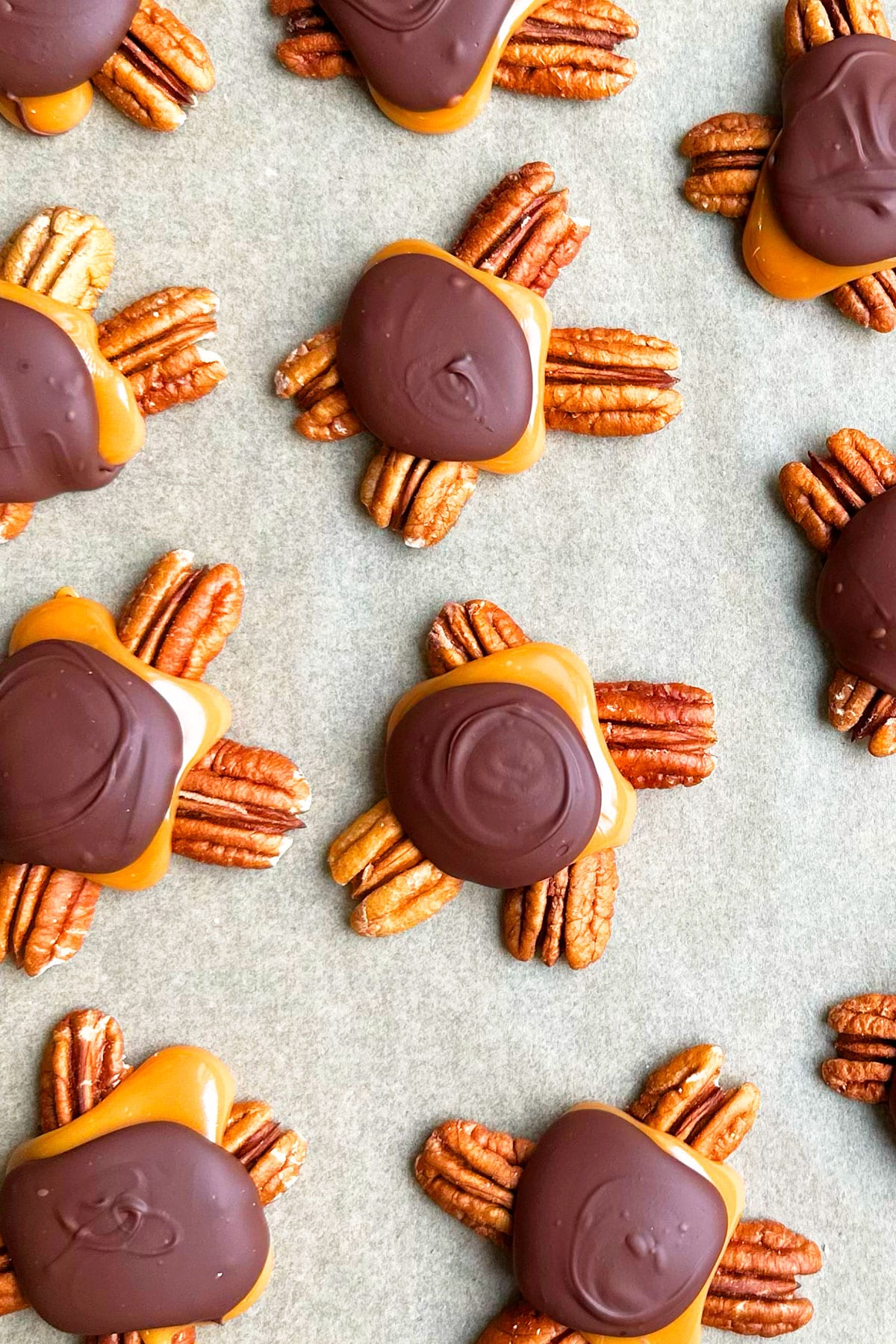 Easy Homemade Chocolate Turtles on Brown Wax Paper- Overhead Shot. 