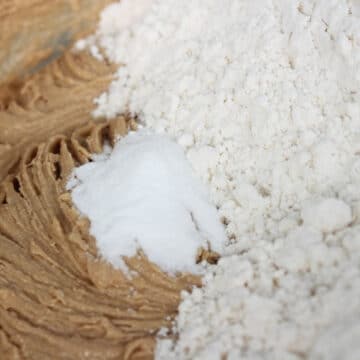 Flour and baking soda added to wet ingredients in large bowl. 