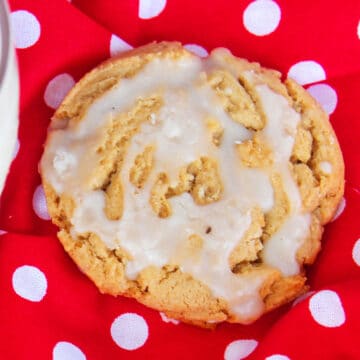 Glazed cookie on red polka dot background. 