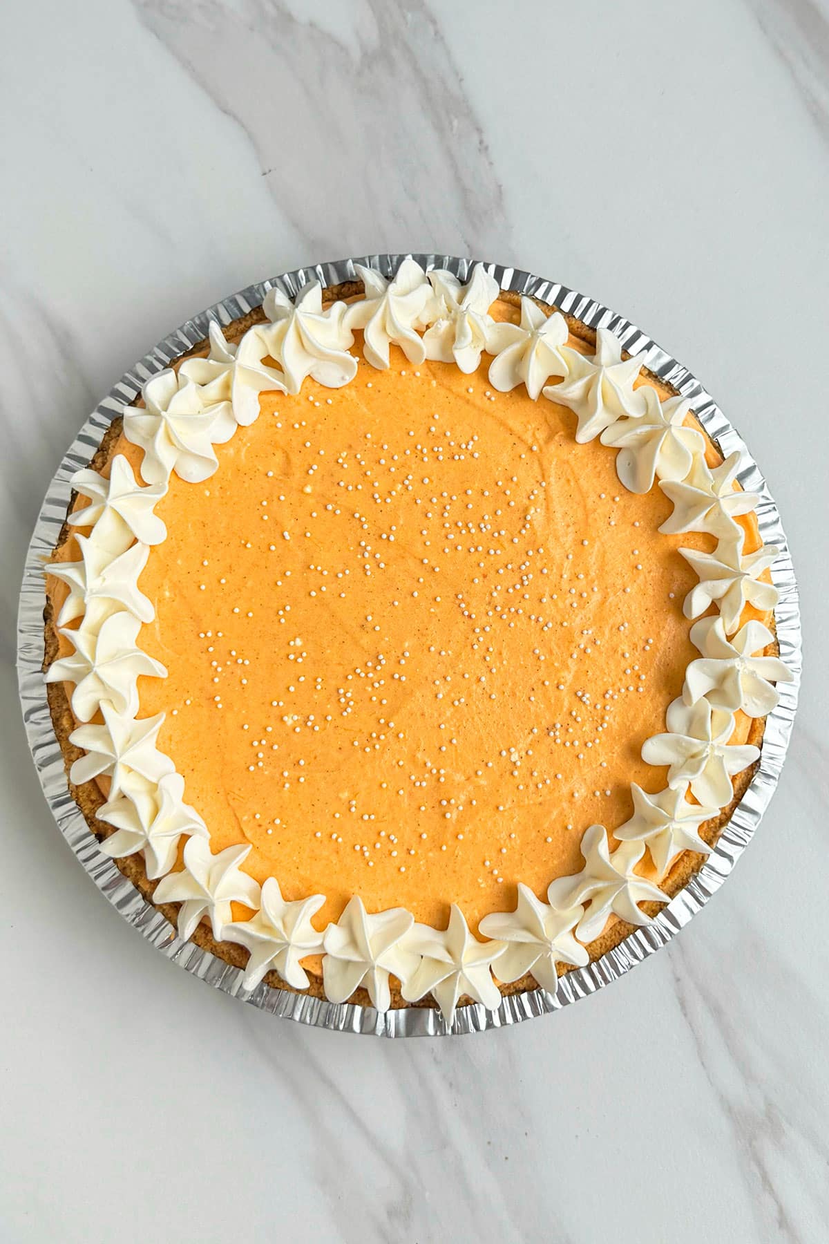 Best Homemade No Bake Thanksgiving Pie on White Marble Background- Overhead Shot. 