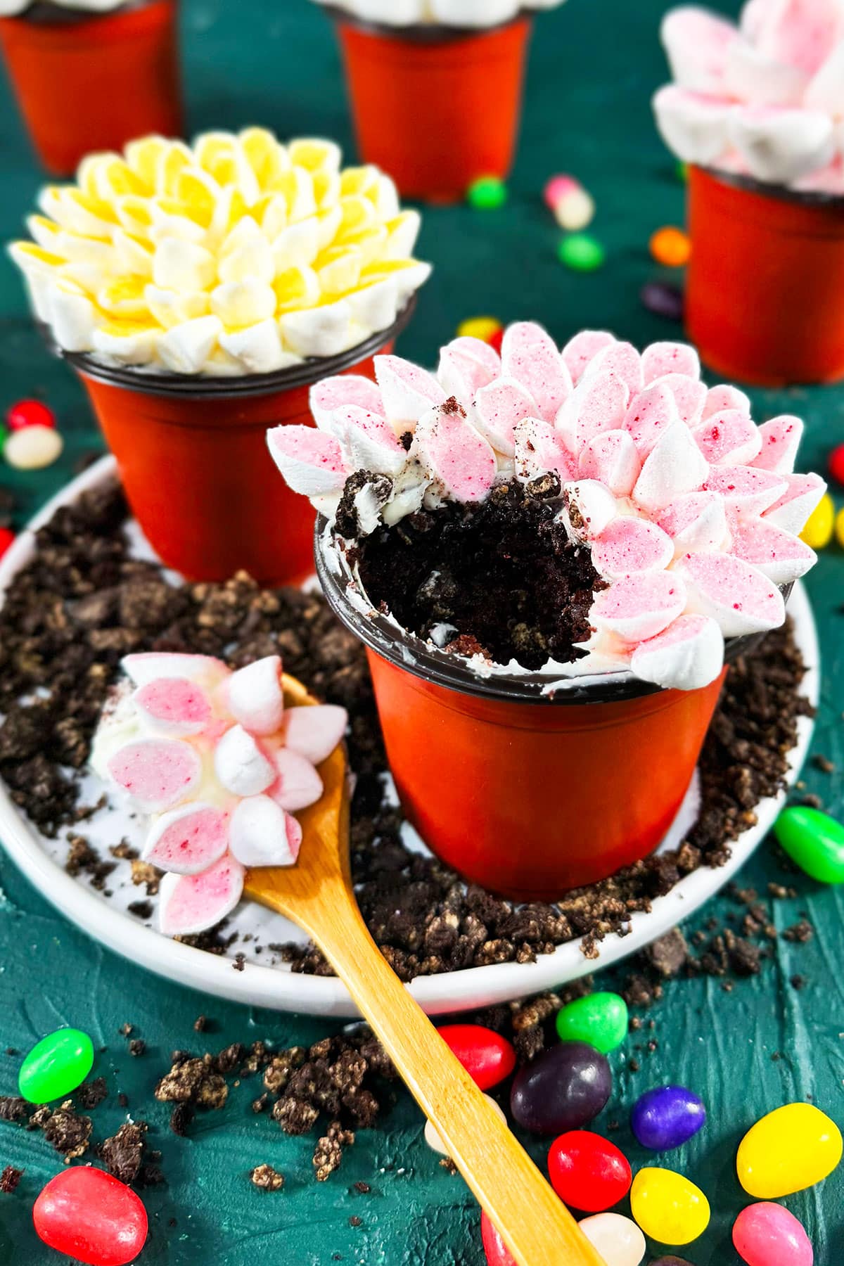 Partially eaten cupcake on white dish with crushed Oreos. 