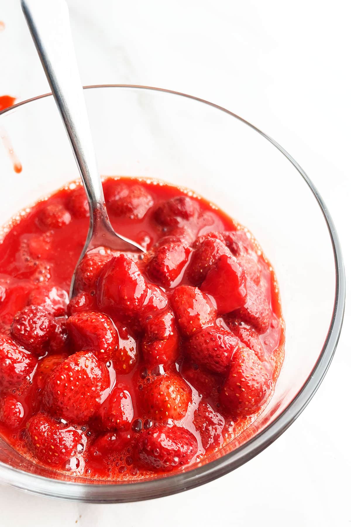 Sweetened strawberries in glass bowl- Closeup shot. 