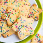 Easy Star Shaped Cut Out Funfetti Cookies With Rainbow Sprinkles on White and Green Dish.