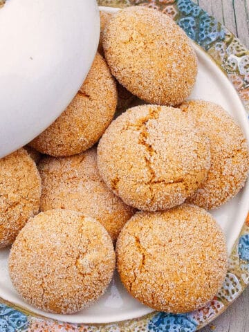 Best Easy Ginger Molasses Cookies in White Dish With Colorful Rim on Rustic Gray Background.