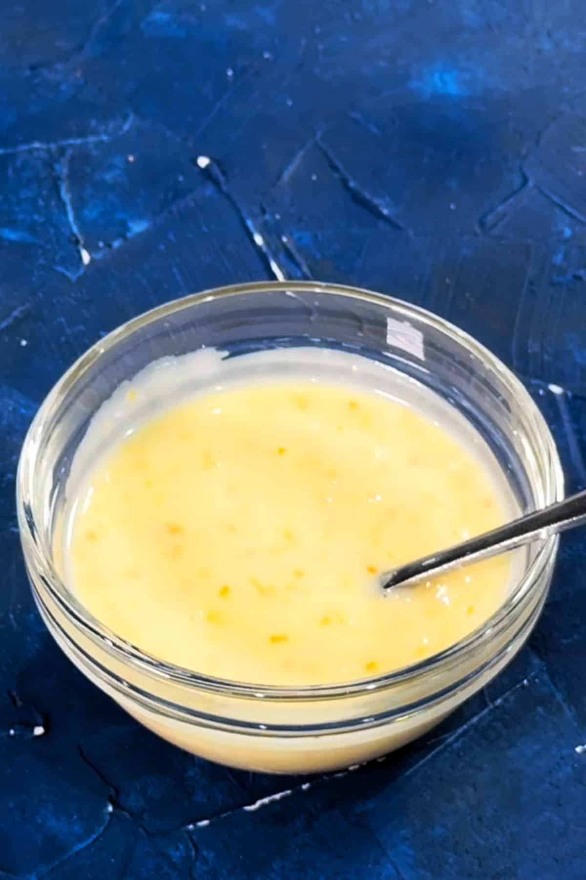 Bowl of citrus topping on blue background. 