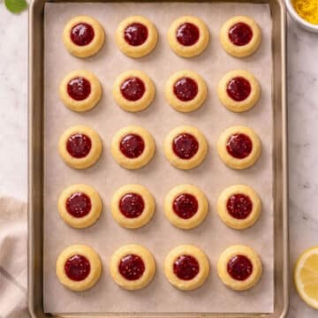 Filled thumbprints on lined baking tray. 