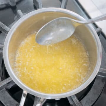 Melted butter being mixed in a saucepan. 